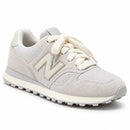 New Balance 574 Off/Cinza — vista frontal oblíqua com a ponta à direita